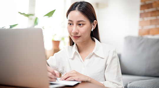 woman attending a webinar on her laptop